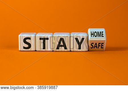 Wooden Cube Form The Expression 'stay Home, Stay Safe'. Beautiful Orange Background, Copy Space. Cov