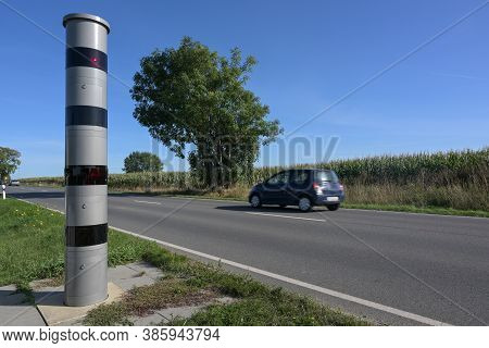 Stationary Speed Limit Enforcement Beside A Road And A Blurred Passing Car, Traffic Monitoring With 