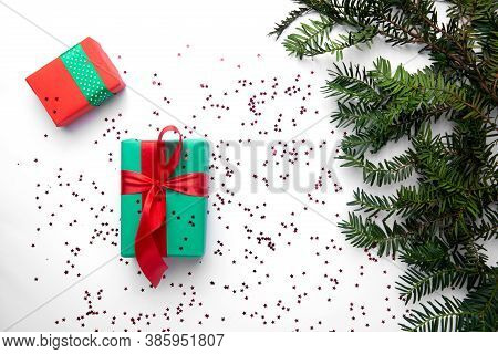 Two Christmas Gifts On The White Background And Christmas Tree