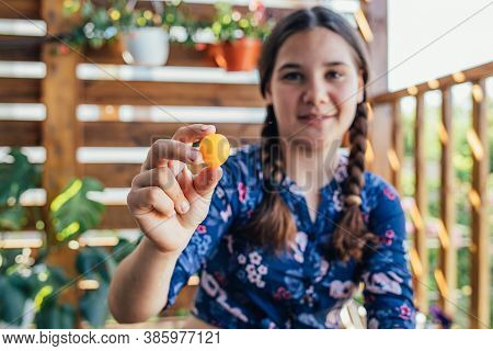 Young Girl Holding Yellow Fruits In Her Hands, Healthy Breakfast, Snack. Selective Focus