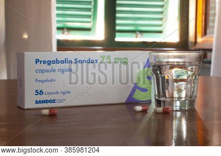 Carrara, Italy - September 19, 2020 - A Box And Some Pills Of Pregabalin On A Table With A Glass Of 