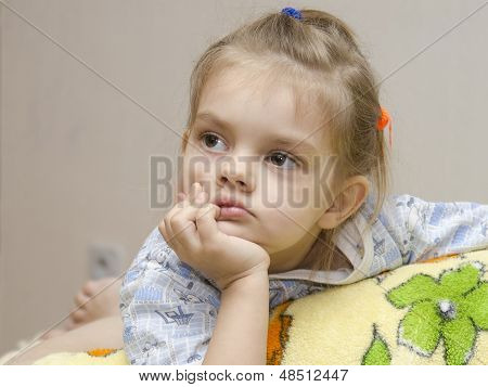 A four year old girl enthusiastically look left