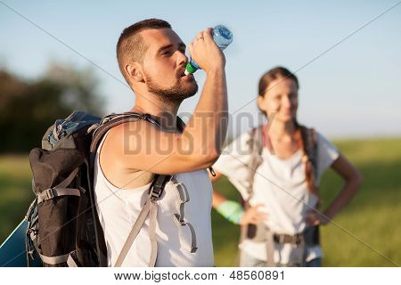 Two tourists with backpacks on the plateau.