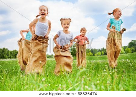 Five kids jump in sacks