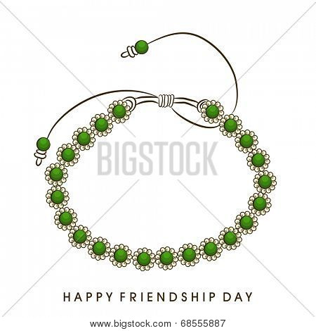 Green pearl decorated friendship band on white background for Happy Friendship Day celebrations. 