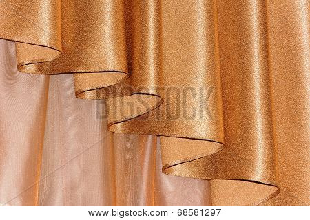 Open lambrequin (portiere, curtain) golden color on the window.