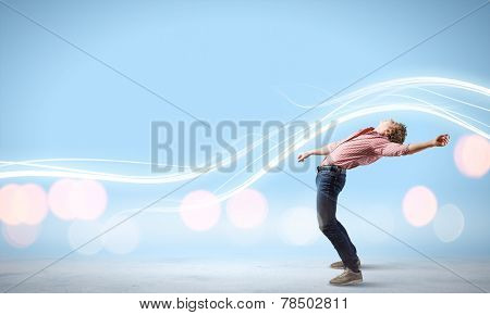 Young guy in casual evading from light rays