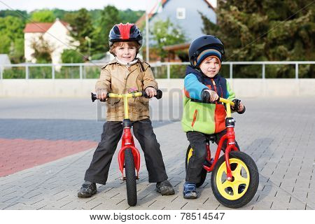 Two Little Siblings Having Fun On Bikes In City On Vacations