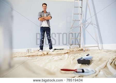 Portrait Of Man Decorating Nursery For New Baby
