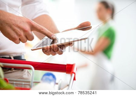 Customer With Tablet At Supermarket