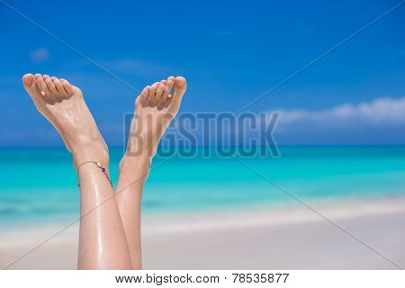 Close Up Of Female Feet On White Sandy Beach