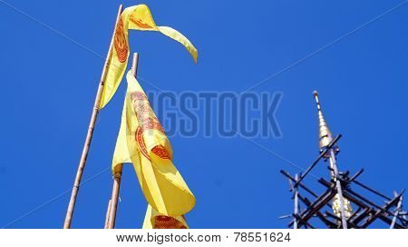 buddhist yellow flag with pagoda top. The Dharmacakra flag symbol of Buddhism in Thailand.
