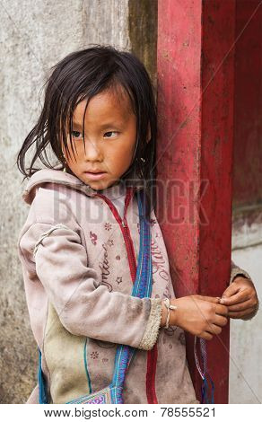 SAPA, VIETNAM - JUNE 10, 2011: Unidentified vietnamese girl in Ta Van village. Though Vietnam's economic growth rate is among the highest in the world, poverty rate is still high