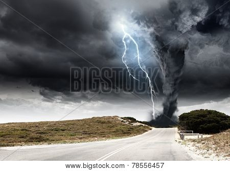 Powerful tornado and lightning above countryside road