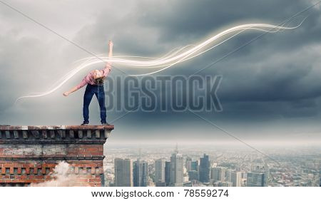 Young guy in casual evading from light rays