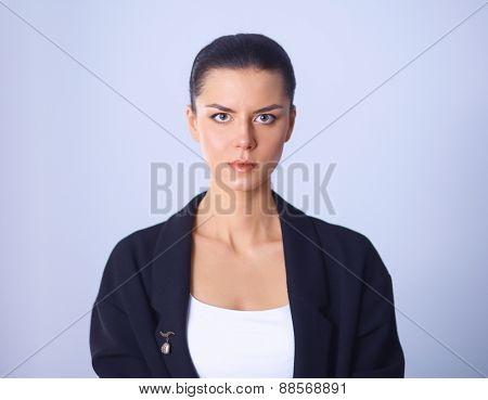 A young woman standing, isolated on graybackground