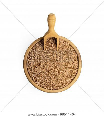 Buckwheat groats in a bowl and wooden scoop