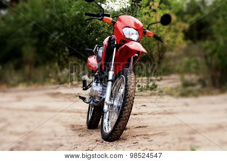 Cross motorcycle on kickstand at the ground road
