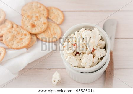 chunks of cheese with sundried tomatoes, herbs and spices
