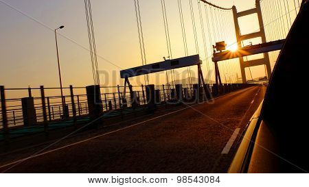 driving on the bridge before sunset