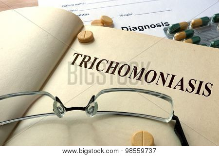 Word Trichomoniasis on a paper and pills.