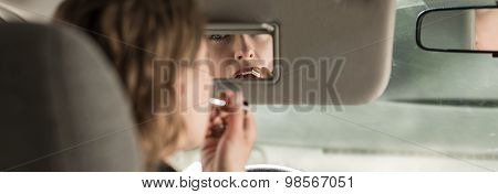 Woman Puting The Lipstick On