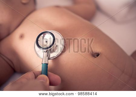 Pediatric Doctor Exams Newborn Baby Girl With Stethoscope In Hospital