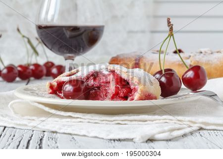 Slice Of Cherry Pie On A Linen Napkin With Polka Dots. A Cake Decorated With Fresh Cherries. Next To