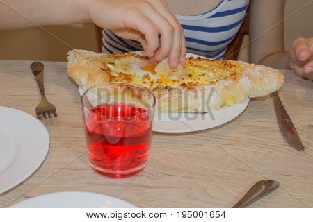 Khachapuri raditional Georgian cheese-filled bread Ajarian style. Adjarian khachapuri with eggs on the table