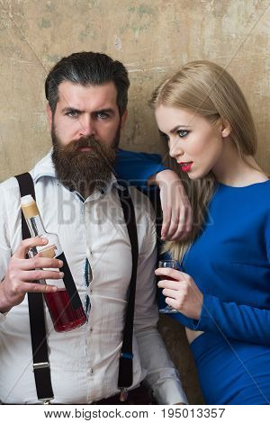 Man And Woman Posing With Bottle And Glass Of Liqueur