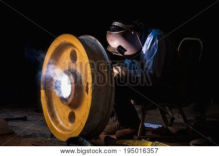 Industrial welder wear safety protective mask welding fabricated construction in factory Welding process by Shielded Metal Arc Welding (SMAW) or Stick Welding.
