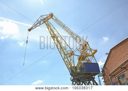 Hoisting crane against blue sky