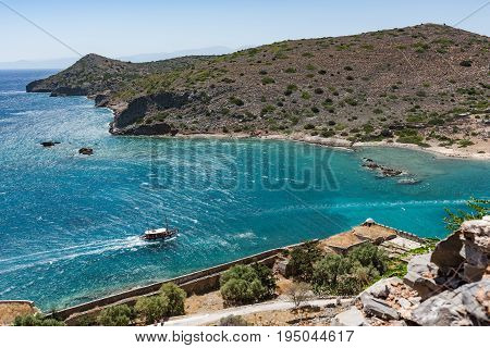 View From Top Of Spinalonga Island. Blue Sea With Boat And Kalydon Island In Front.