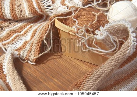 Balls of wool and knitting on the wooden background