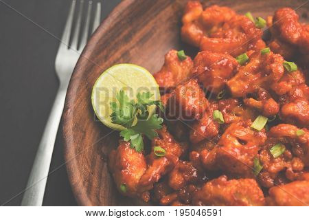 Gobi Manchurian dry - Popular street food of India made of cauliflower florets, selective focus