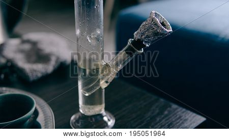 .smoking Marijuana With A Bong Close-up . Legalization And Dependence On Light Drugs