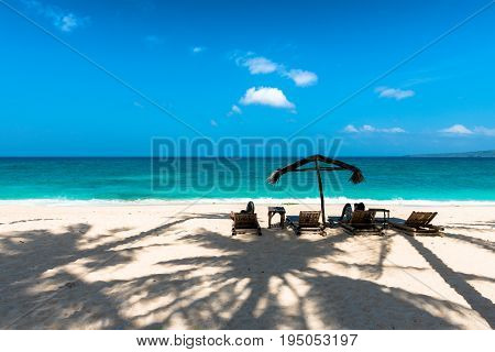 BORACAY WESTERN VISAYAS PHILIPPINES - JANUARY 14 2015: Two people lying down under the tent to protect from the sun at Puka Beach.