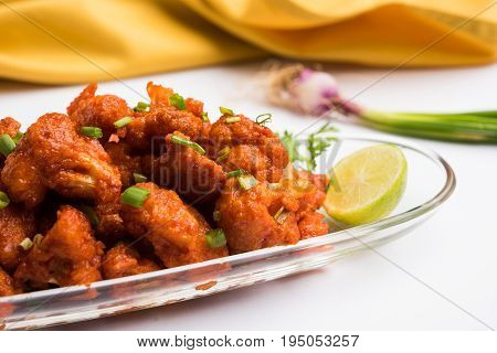 Gobi Manchurian dry - Popular street food of India made of cauliflower florets, selective focus