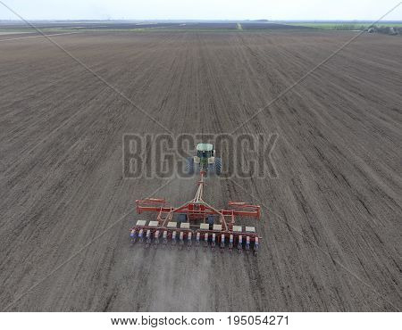 Sowing Of Corn. Tractor With A Seeder On The Field. Using A Seeder For Planting Corn.