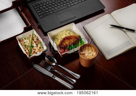 Business lunch on the desktop of the computer on one person