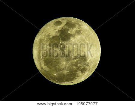 Close up of the yellow full moon texture in the night time. Full moon isolated on black background.