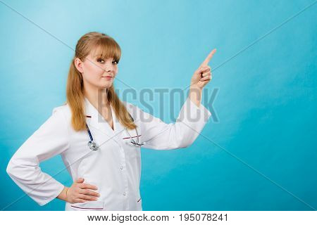 Medicine and healthcare. Portrait of young smiling female doctor. Woman professionalist in white medical uniform showing copy space.
