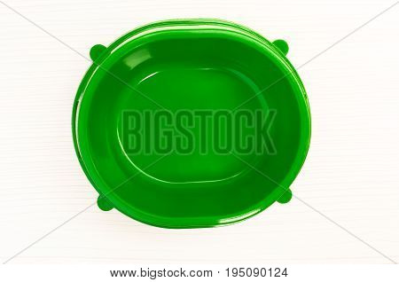 green empty plastic bowl for feeding animals