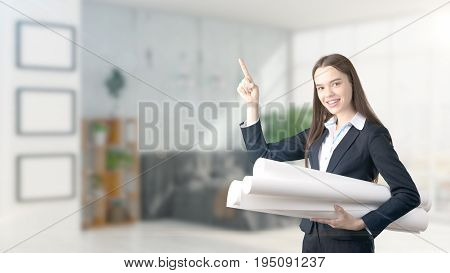 Young Beautiful Business Woman And Creative Designer Standing Over Blured Interior Background