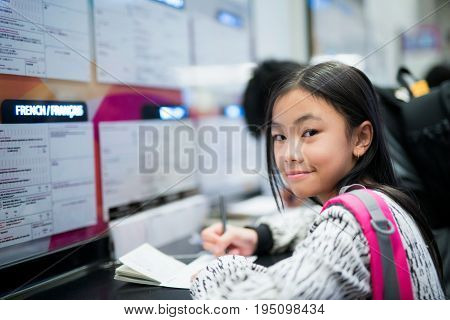 Asian student prepare passport and write a immigration ducument in an international airport travel and people concept