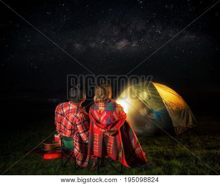 Picknic and camping concept man and lady sit and look at star milky way and meteor love and valentine day