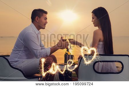 Asian couple in romantic dinner with sea beach and sunset in Thialand island. love valentine summer and honymoon concept.