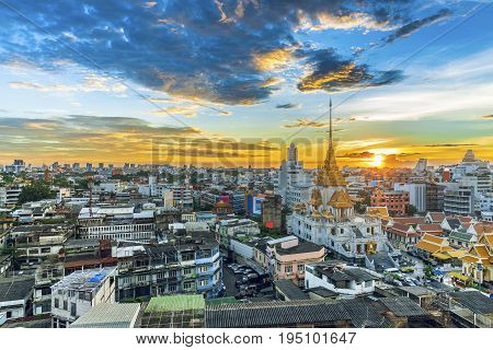 Panorama on skyscraper The top of landmark in Bangkok Trimitr temple is the biggest golden buddha in the world Cityscape is golden light in Twilight The temple at Yaowarat Road Bangkok Thailand.