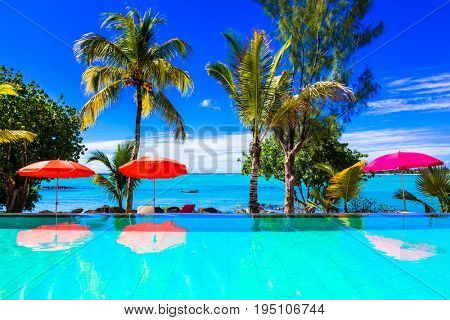 Tropical vacation - turquoise swim pool  with sea view. Mauritius island