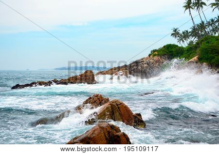 The coast of stormy ocean with waves beating against the rocks
